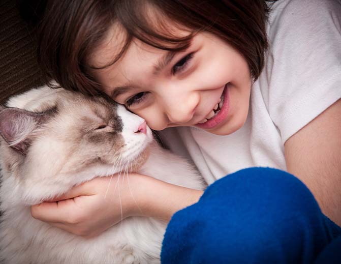 Girl hugging cat